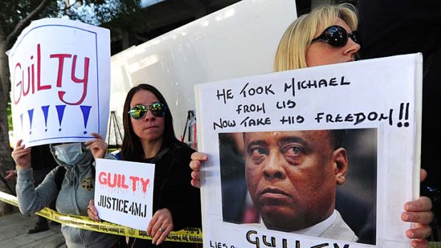 Supporters of Michael Jackson hold placards awaiting the verdict of his doctor's trial in Los Angeles.
