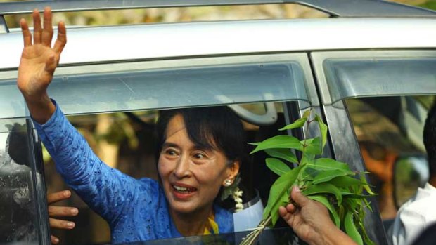 Aung San Suu Kyi greets supporters at an electoral campaign rally in Kawhmu.