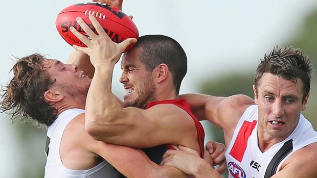 Tight in close ... St Kilda's Jack Steven and Melbourne's James Magner fight for the ball.