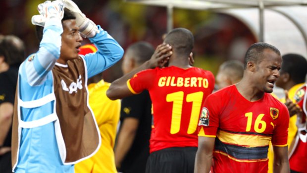 Shock ... Angola's Flavio, right, and Alegre Wilson, left, react at the end of the game.