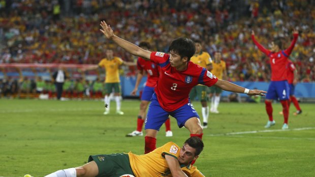 Fouled but not out: Tomi Juric of Australia competes for the ball before setting up the winning goal by James Troisi.