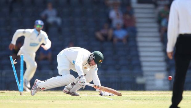 Embarrassing dismissal: Ben Dunk was given out hit wicket, slipping and stepping back on his middle stump after he was stood up by a quick Doug Bollinger delivery.