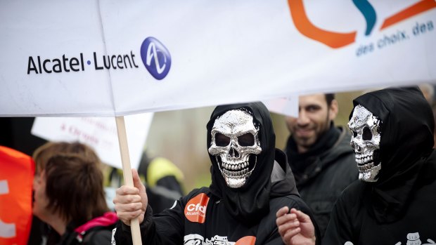 Alcatel-Lucent employees protest against the company's planned job-cuts on October 22, 2013 in Nantes, France.
