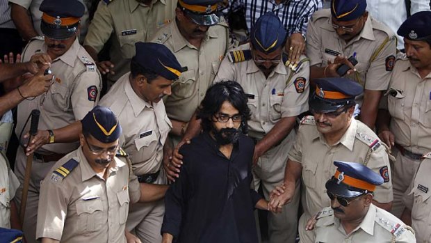 ''Intolerant India'' ... Aseem Trivedi is led out of the Mumbai magistrate court after his arrest on sedition charges for lampooning government corruption.