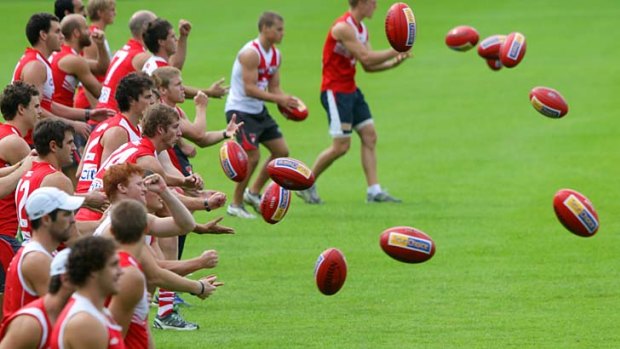 The ball's in your court . . . the Swans, training at the SCG yesterday, still have to work hard to attract crowds in a busy Sydney sports market.