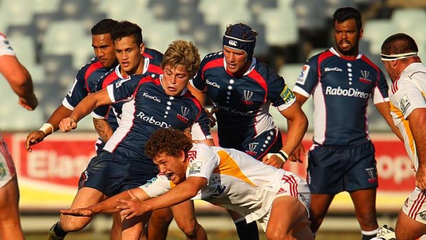 James O'Connor of the Rebels competes for the ball as Kurtley Beale (second right) looks on during the Super Rugby trial match between the Rebels and the Chiefs.