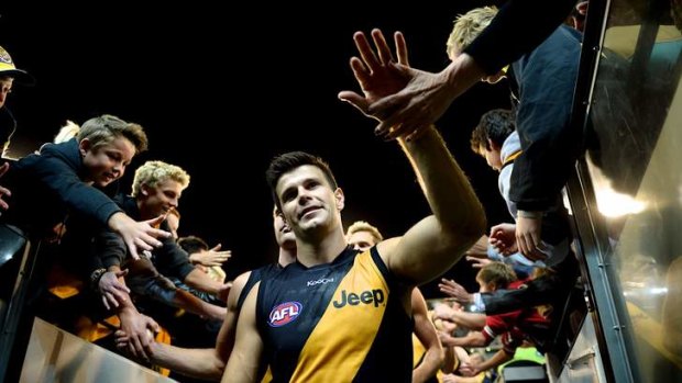 Trent Cotchin celebrates the round-one victory over Carlton with fans.