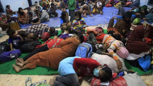 Villagers evacuated from their homes due to Mount Kelud's eruptions, sleep on the floor at a temporary shelter at Sumber Agung village in Kedir.