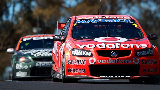 Holden driver Jamie Whincup leads David Reynolds, in the FPR Ford, to the chequered flag in the Bathurst 1000's closest finish at Mount Panorama yesterday.
