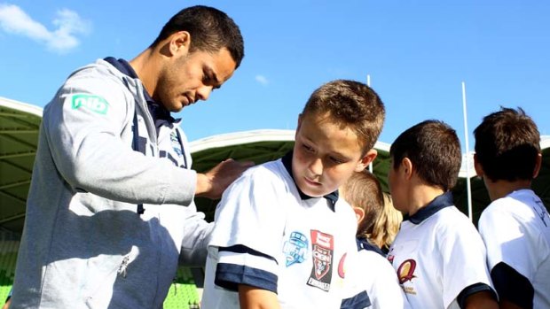 The write stuff &#8230; Jarryd Hayne signs autographs for children during an Origin skills clinic in Melbourne.