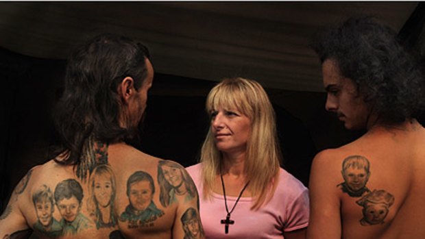 Peter Petkovski, left, with tattoos of sons Pauly and Ricky, his wife, Lena, sons Tony and Mark, sister Vera and brother Luke; Lena; and Ricky, with a tattoo of two of his brothers, Tony and Mark.