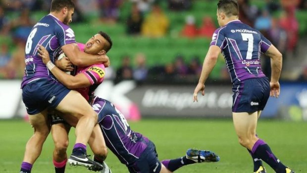 Dean Whare of the Panthers is tackled by Jesse Bromwich (left).
