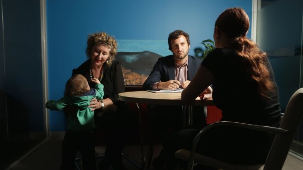 A mother and one of her children children with lawyer Patrick Warner and social worker Antoinette Rosso seeking help from Justice Connect, a legal clinic for women who are at risk of becoming homeless due to family violence.