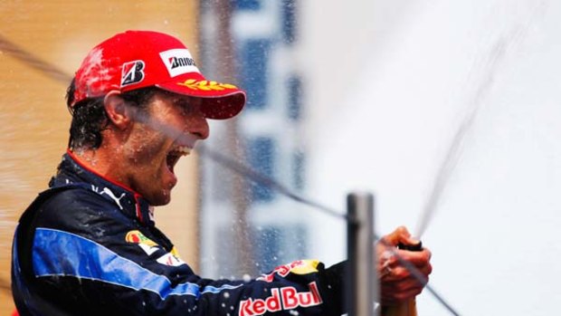 Winner ... Mark Webber celebrates.