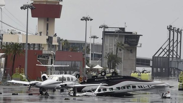 Damaged aircraft sit at the international airport at San Jose del Cabo.