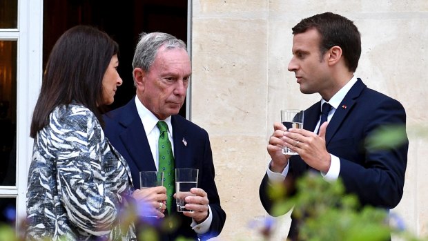 French President Emmanuel Macron, right, Paris mayor Anne Hidalgo, left, and former mayor of New York City Michael Bloomberg meet at the Elysee Palace in Paris on Friday.