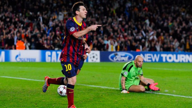 Lionel Messi celebrates after scoring his team's third goal against AC Milan.