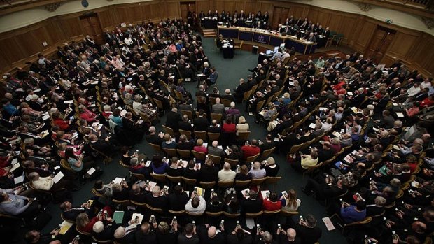 Members vote on handsets to decide whether to give final approval to legislation introducing the first women bishops, during a meeting of the General Synod of the Church of England in London.
