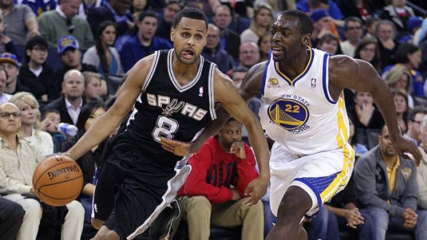 In control: Patty Mills (left) is chased by Charles Jenkins.