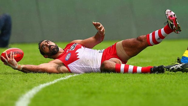 Eye on the ball: Adam Goodes controls the ball over the line in the Swans' victory over the Suns on Saturday at the SCG.