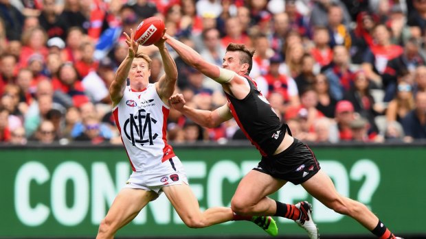 Serious talent: Essendon's Michael Hartley, seen here going up against the Demons' Aaron Vandenberg, has been one of the bright spots in an otherwise tough season for the Bombers. 