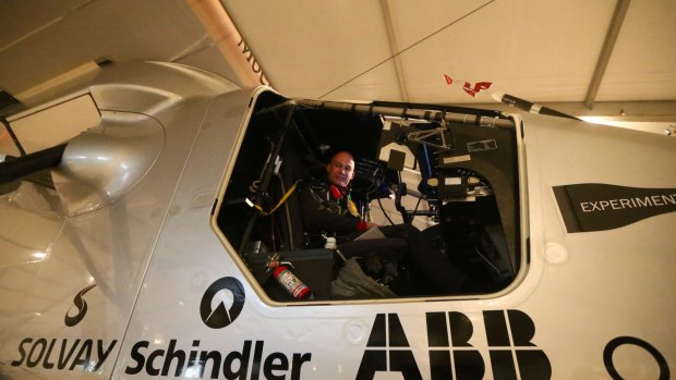 Bertrand Piccard, one of the two Swiss pilots of the solar-powered plane Solar Impluse 2, sits in the cockpit before a third test flight early on Monday at the Emirati capital Abu Dhabi's small Al-Bateen airport.