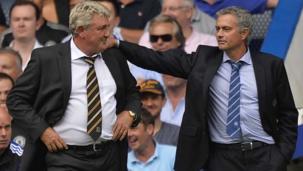 Friendly fire: A "more mature" Mourinho with Hull City manager Steve Bruce on the touchline on Sunday.