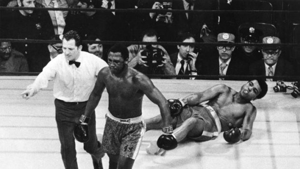 Joe Frazier knocks down Muhammad Ali.