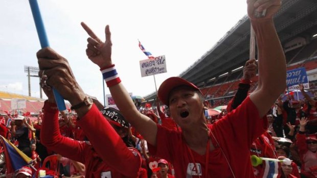 Preparing to take to the streets again: Pro-government "red shirt" supporters react during a rally in November.