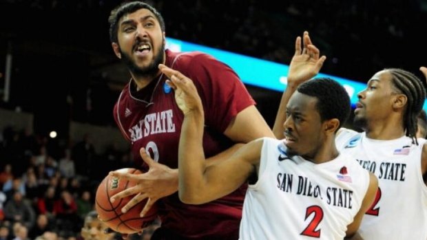 Giant customer: Sim Bhullar stands tall while playing for New Mexico State University.