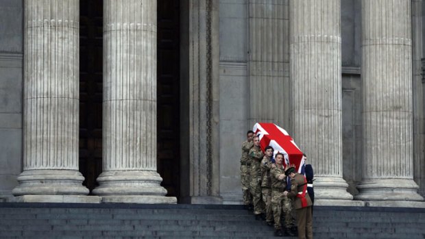 British forces' officers carry a Union Jack-draped coffin outside St Paul's Cathedral during the rehearsal for the upcoming funeral of former British PM Margaret Thatcher.