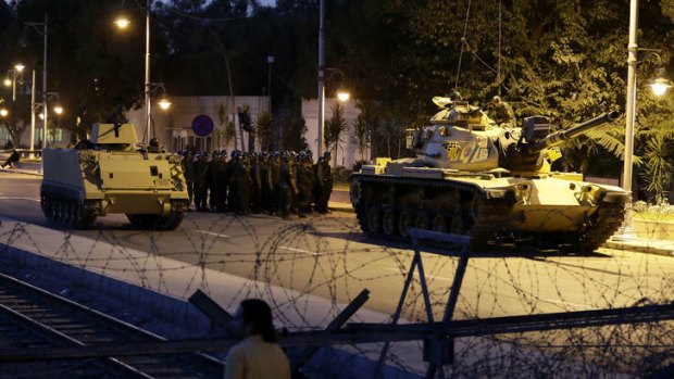 Escalating crisis .... an Egyptian Army tank deployed outside the presidential palace.