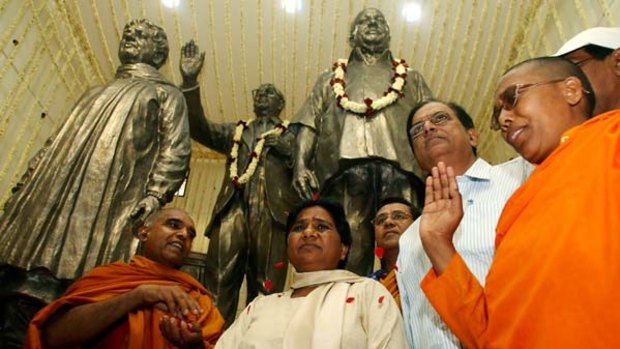 Kumari Mayawati (second from left) in Delhi with supporters. Behind them are statues of (from left) Ms Mayawati and former dalit leaders B.R. Ambedkar and Kanshi Ram. PICTURE: AFP
