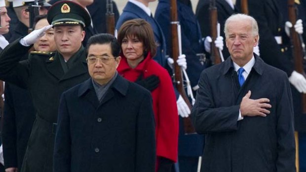 Chinese President Hu Jintao and US Vice-President Joe Biden listen to the Chinese national anthem at Andrews Air Force Base in Maryland.