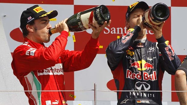 Drink up ... Fernando Alonso and Sebastian Vettel.