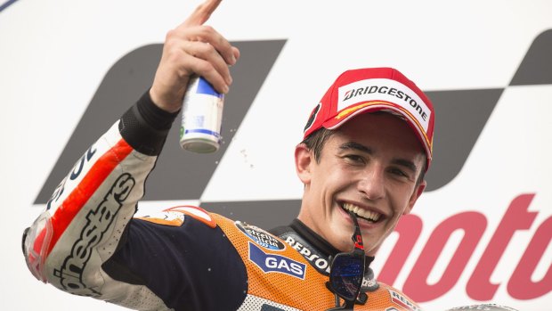 Marc Marquez waves to the crowd from the podium after his win.