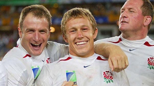 Mike Catt, left, celebrates winning the World Cup in Sydney in 2003 with Jonny Wilkinson and Richard Hill.