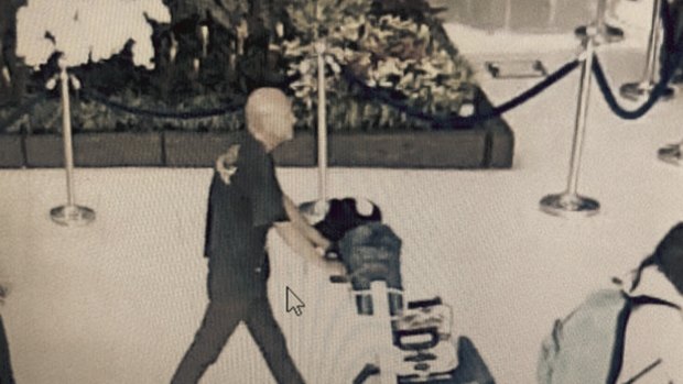 CCTV footage shows a man identified as Australian John Robertson with a trolley loaded with bags belonging to a Thai traveller.