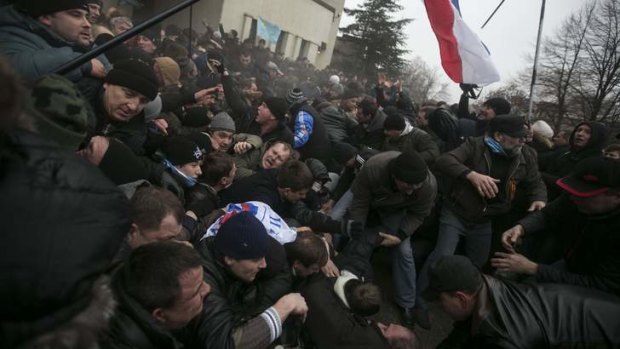 Clashes between pro-Russian demonstrators and supporters of the new Ukrainian regime building in Simferopol, Crimea.
