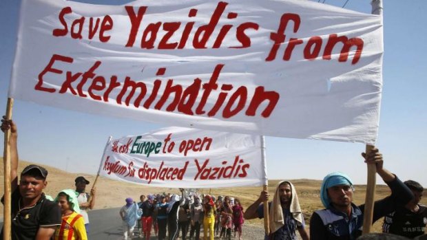 Displaced people from the minority Yazidi sect, who fled the violence in the Iraqi town of Sinjar, take part in a demonstration at the Iraqi-Syrian border crossing in Fishkhabour, Dohuk. 