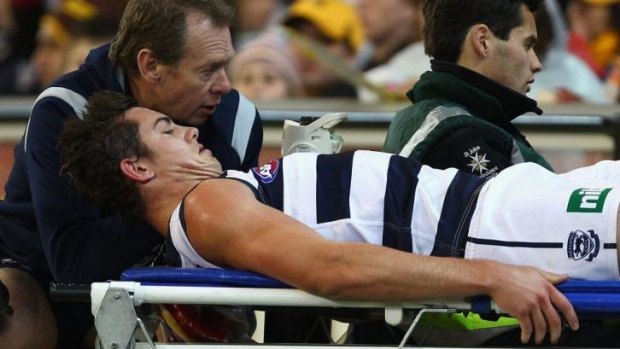 Daniel Menzel is stretchered from the ground during the 2011 finals.