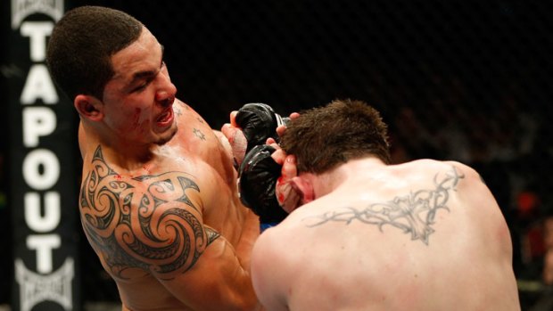 Australian UFC fighter Robert Whittaker (right) lands an uppercut on his way to victory in the TUF: The Smashes welterweight final against Team UK fighter Brad Scott on the Gold Coast in December.