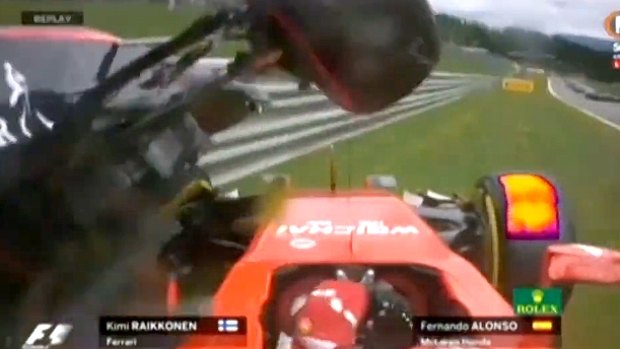 Fernando Alonso's McLaren rides on top of Kimi Raikkonen's Ferrari.