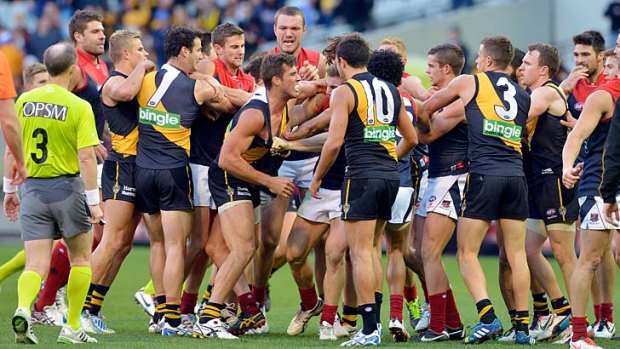 Richmond and Melbourne players get involved in a brawl at half-time.