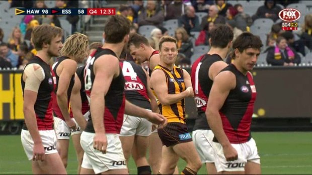 Hawthorn's Sam Mitchell taunts Essendon players, by feigning giving himself an injection.