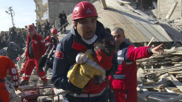 A rescue worker in Turkey carries an infant to an ambulance after his team found her alive in a collapsed building.