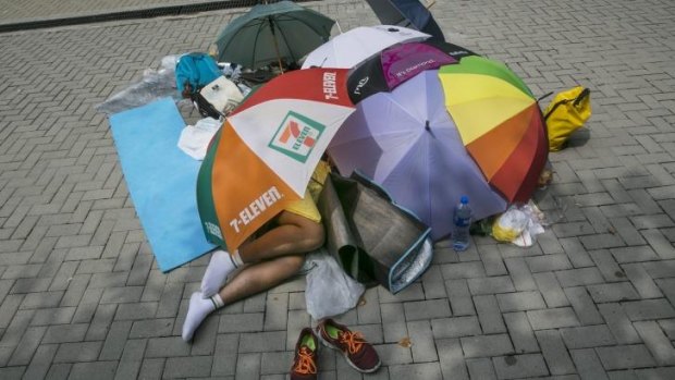 Umbrella revolution: A student protester sleeps under umbrellas during a quiet moment.