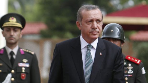Turkey's president Recep Tayyip Erdogan inspects an honour guard during a welcoming ceremony.