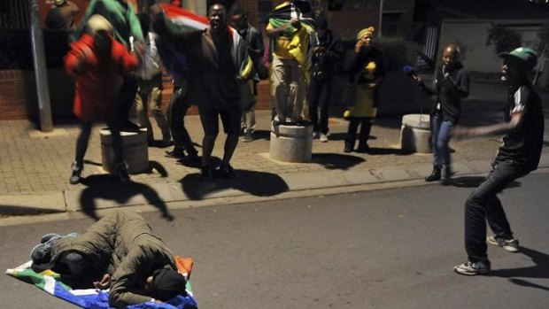 Sowetans mourn the death of former president Nelson Mandela outside Mandela's former home, now a museum, in Soweto.