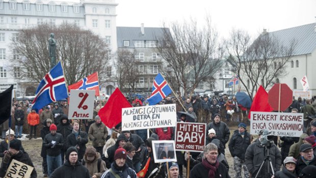 Taking to the streets ... protesters outside the Icelandic parliament in Reykjavik .